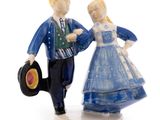 a figurine of a man and a woman holding a record