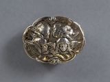 an antique silver plate with a design of flowers and birds on it
