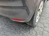 a close up of a car ' s rear end with a broken tire