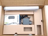 a box with a laptop and a charger inside of it
