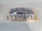 a toy car in a plastic box on a table