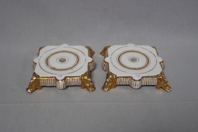 pair of gold and white porcelain candlesticks with gold trim