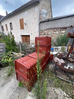 a pile of red boxes sitting in front of a building