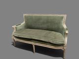 a green couch that is sitting on a gray surface