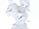 a white statue of an angel and a man on a horse