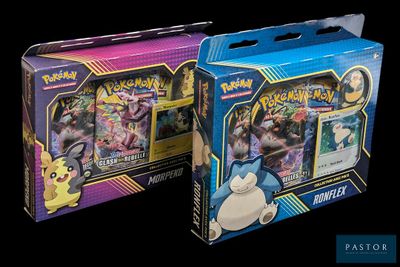 two boxes of pokemon cards are shown on a black background