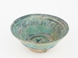 a small green bowl with writing on it