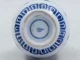 a blue and white vase with a design on it