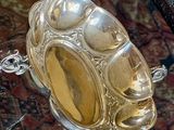 a glass table with a silver plate on top of it