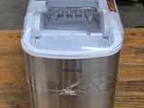 a small ice maker sitting on a wooden table