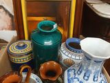 many vases and bowls in a box on the floor
