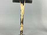 a black and gold crucif with a cross on it