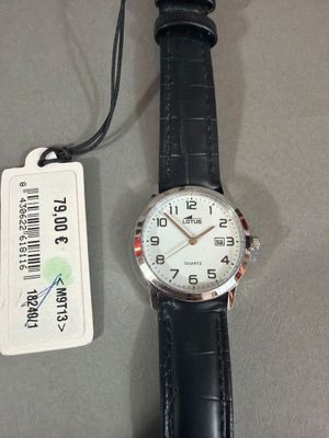une montre posée sur une table à côté d'une étiquette de prix