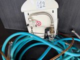a close up of a blue hose connected to a white electrical outlet