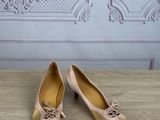 pair of women ' s shoes on a wooden table in front of a wall