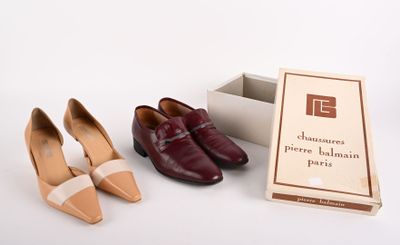 two pairs of shoes that are next to a box