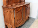 a wooden cabinet with a door on top of it