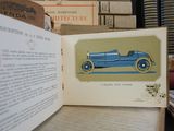 an open book with a picture of a blue car on it