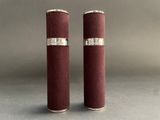 pair of red velvet and silver candles on a grey background