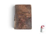 an old book sitting on top of a white surface next to a red and white logo