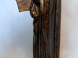 bronze statue of a woman holding a harp and a book
