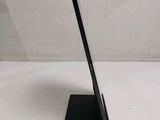 a tablet that is sitting on a stand on a table