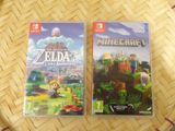two nintendo wii games sitting on top of a wooden table
