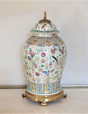 a vase with a lid sitting on a table