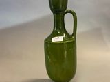 an image of a green vase with a gold top and a light on top of it