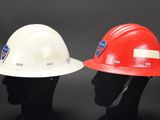two red and white hard hats sitting on top of each other
