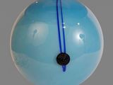 a blue glass ornament hanging from a light fixture