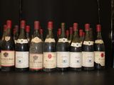 several bottles of wine are lined up in a row on a table