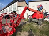 a red crane that is parked in front of a building