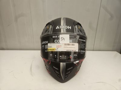 a close up of a helmet on a table with a tag on it