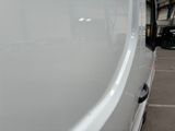 a white van parked in a parking lot next to a building