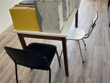 boxes stacked on top of a table with a chair in front of it