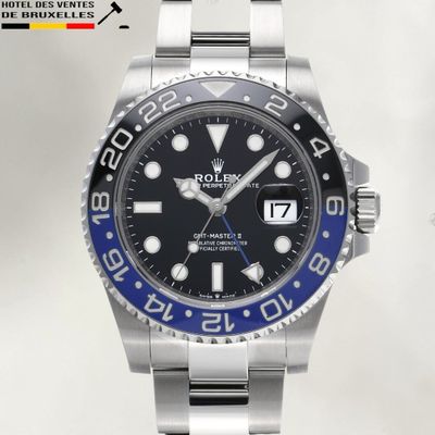 a rolex watch with a blue bezel on the bracelet