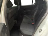 the back seats of a white car with a black seat belt