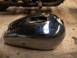 a motorcycle that is parked in a garage with it ' s front end missing