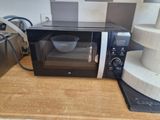 a microwave that is sitting on a counter with a bowl in it
