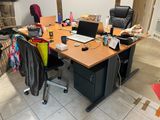a desk with a laptop and a chair in a room