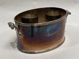 a large metal container with two cups inside of it