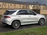 the mercedes gle is parked on the side of the road