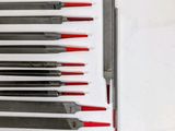 a lot of knives that are lined up on a table