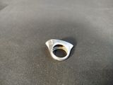 a close up of a silver ring on a black surface