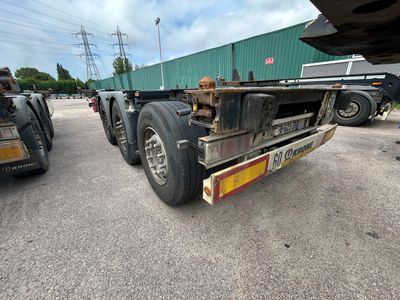 un camion qui est garé sur un terrain avec d'autres camions