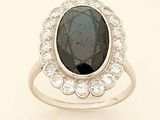 an oval black diamond and white topaz ring