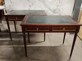 two tables with marble tops and drawers on them in a room