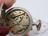 a close up of a pocket watch being held by a person