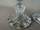 two glass candlesticks that are sitting on a table